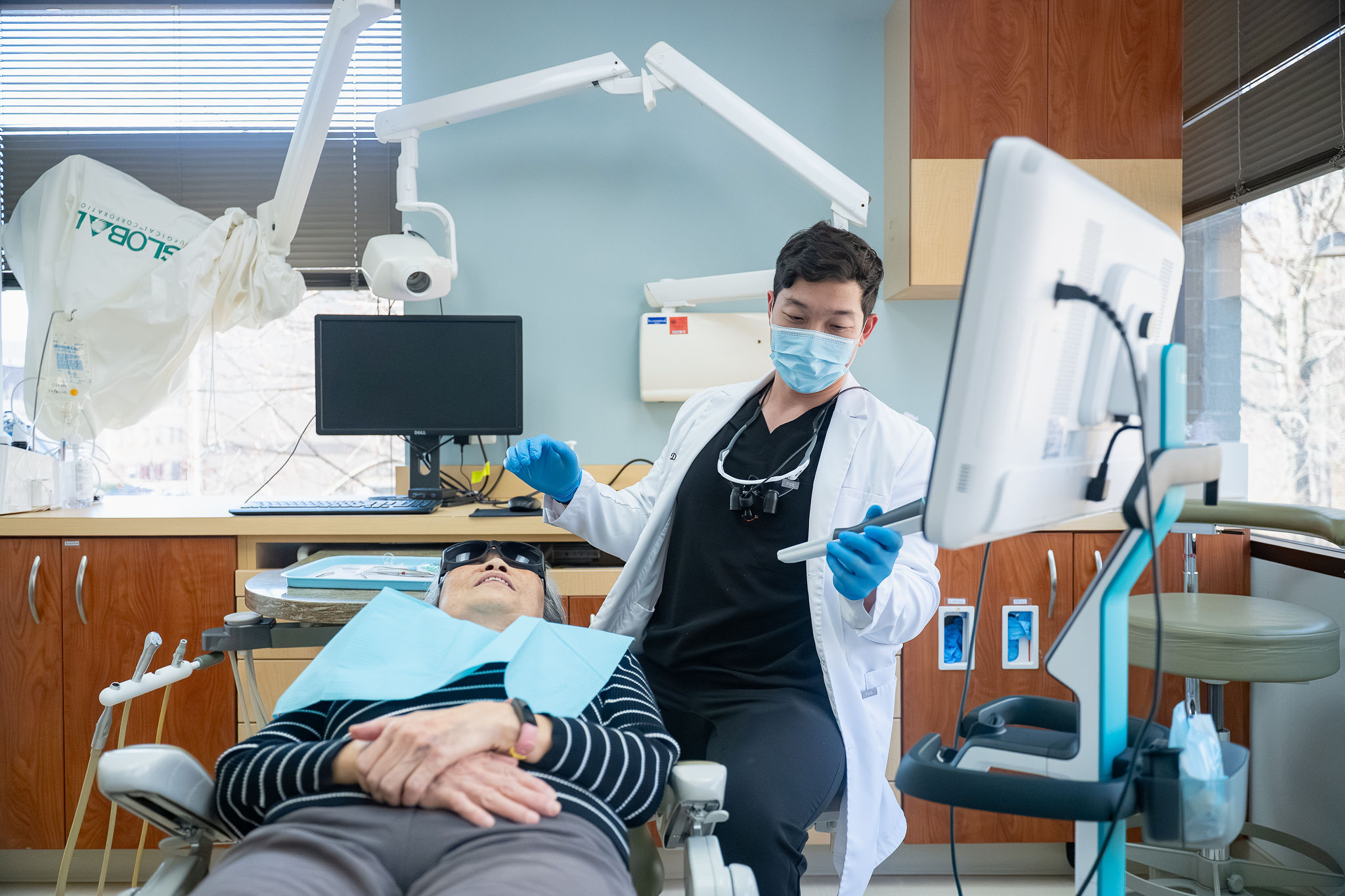 Dr. Andrew Tong board-certified periodontist with patient